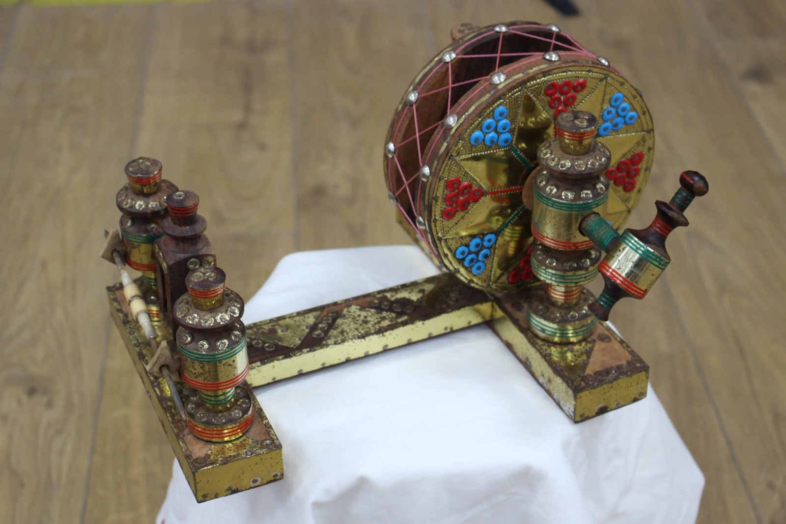 A decorated spinning wheel displayed at the Traces of Empire exhibition