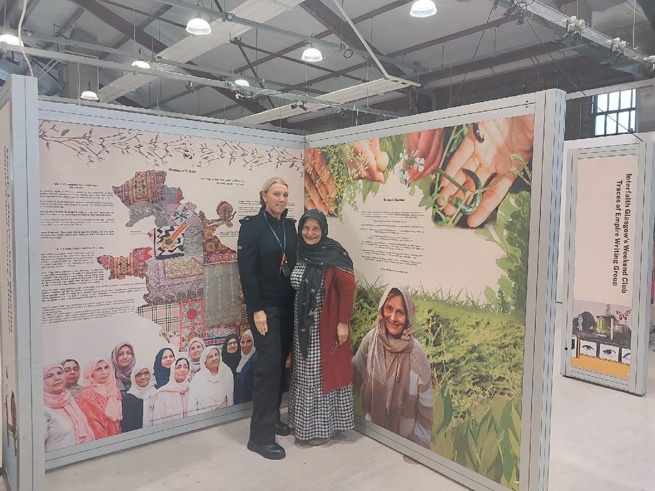 A Police Scotland representative and an exhibition participant beside community history panels at Summerlee