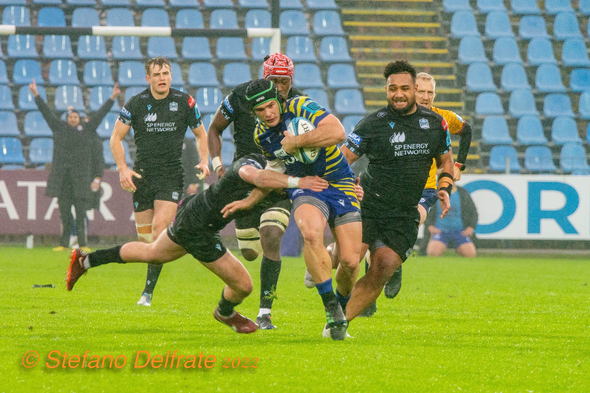 Glasgow Warriors players tackling a Zebre Parma opponent during the 2022–23 United Rugby Championship