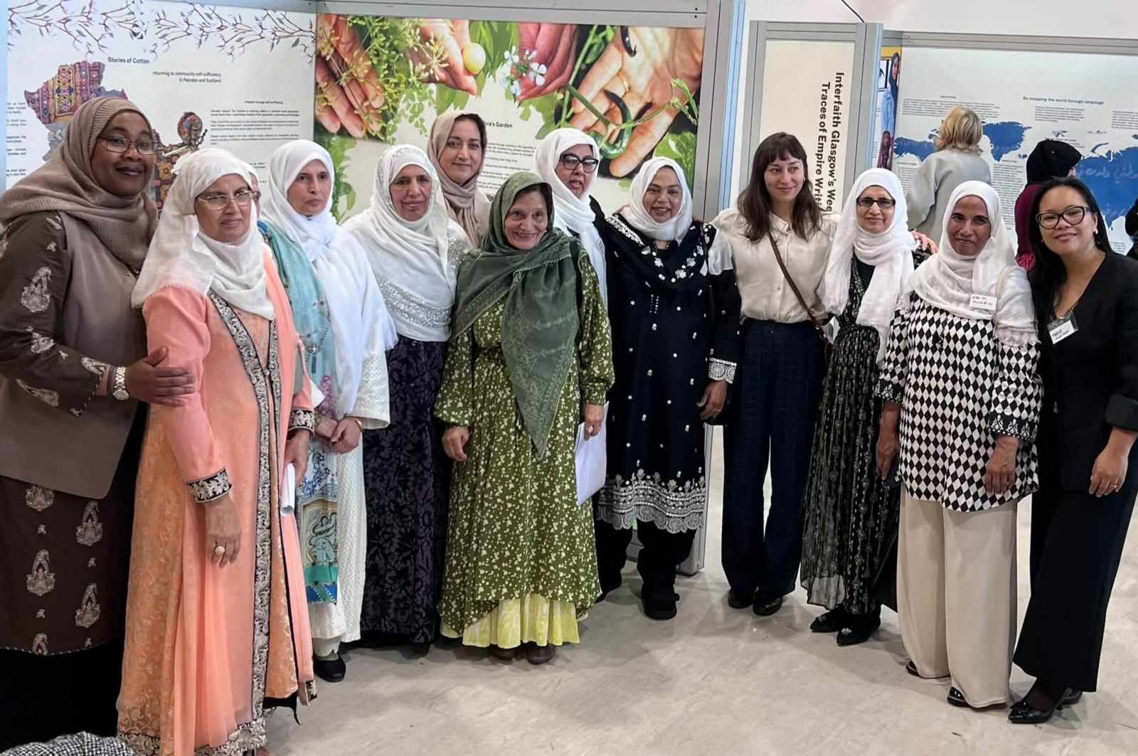The chair and trustees of North Lanarkshire Muslim Women & Family Alliance standing together in front of the Traces of Empire exhibition panels