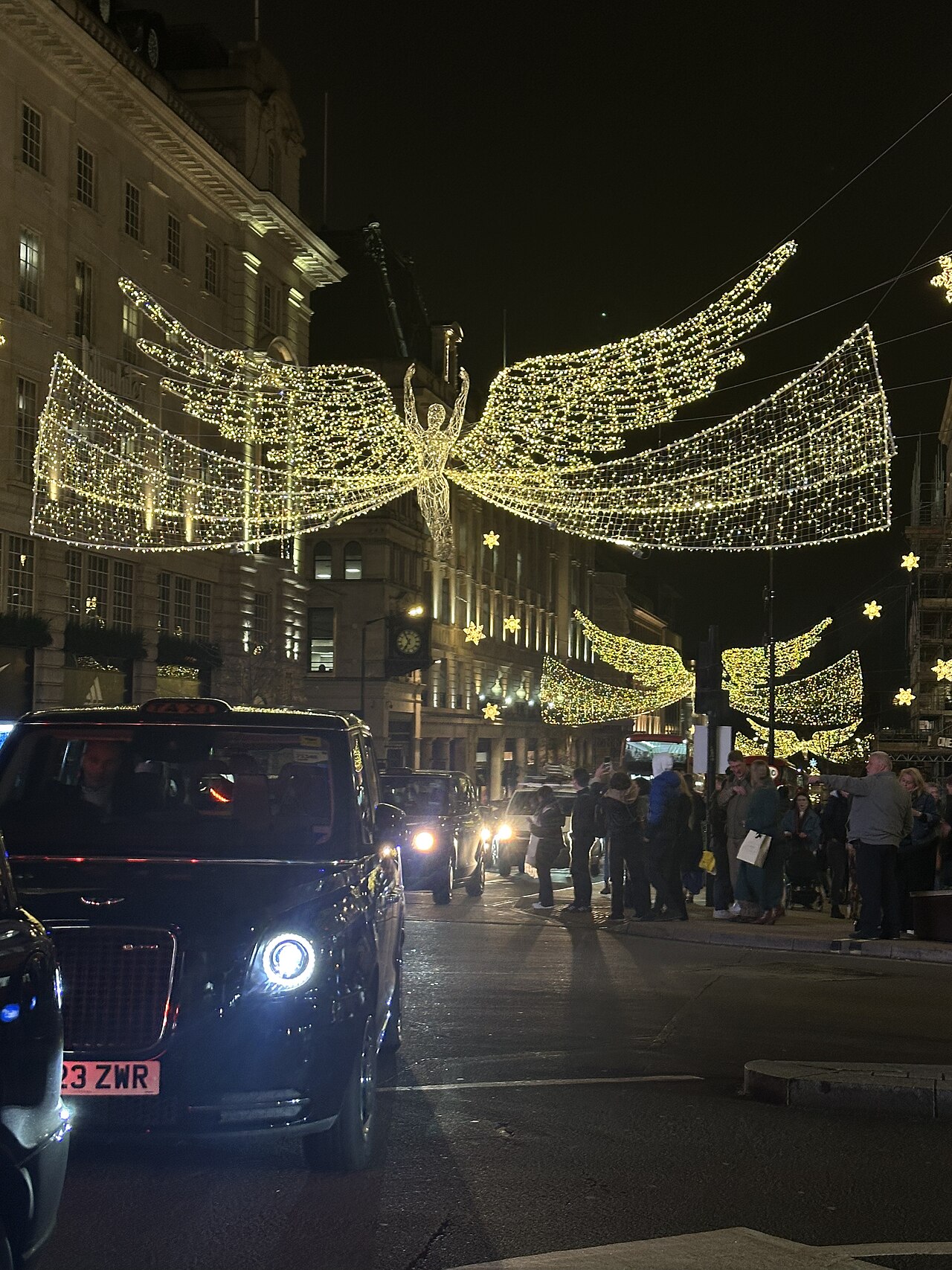 A London black cab travels through Piccadilly Circus