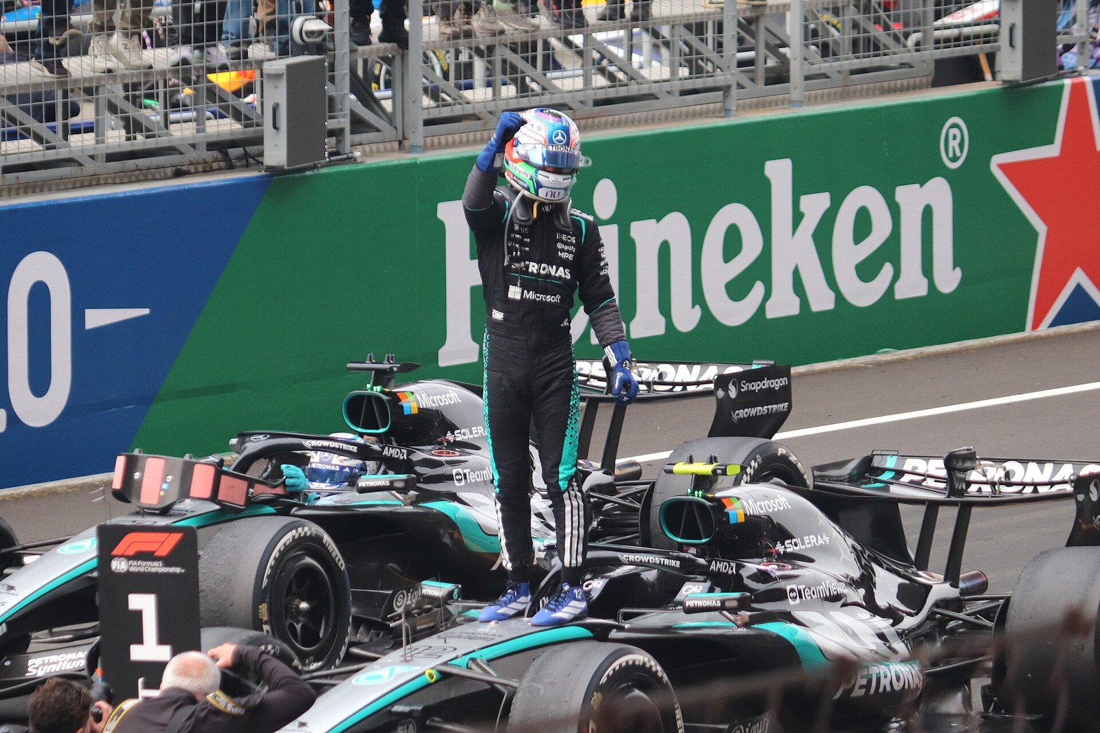 Kimi Antonelli celebrates standing on his Mercedes after the 2026 Chinese Grand Prix