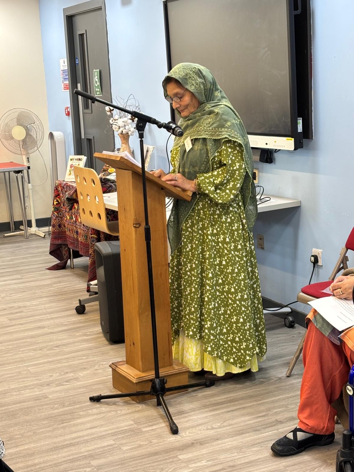Bushra Iqbal MBE, founder and chair of North Lanarkshire Muslim Women & Family Alliance, speaking at a lectern during the Traces of Empire event