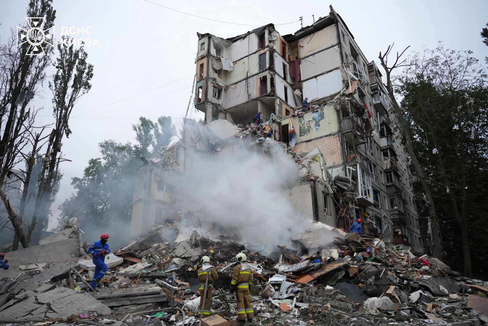 Rescue workers search the rubble of a collapsed apartment block in Kyiv after a Russian missile strike
