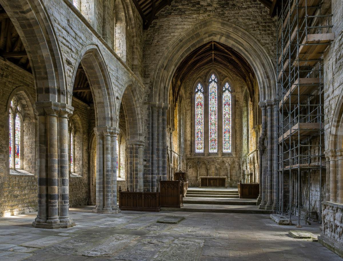 Illustrative image of a historic abbey interior with scaffolding; not a specific church