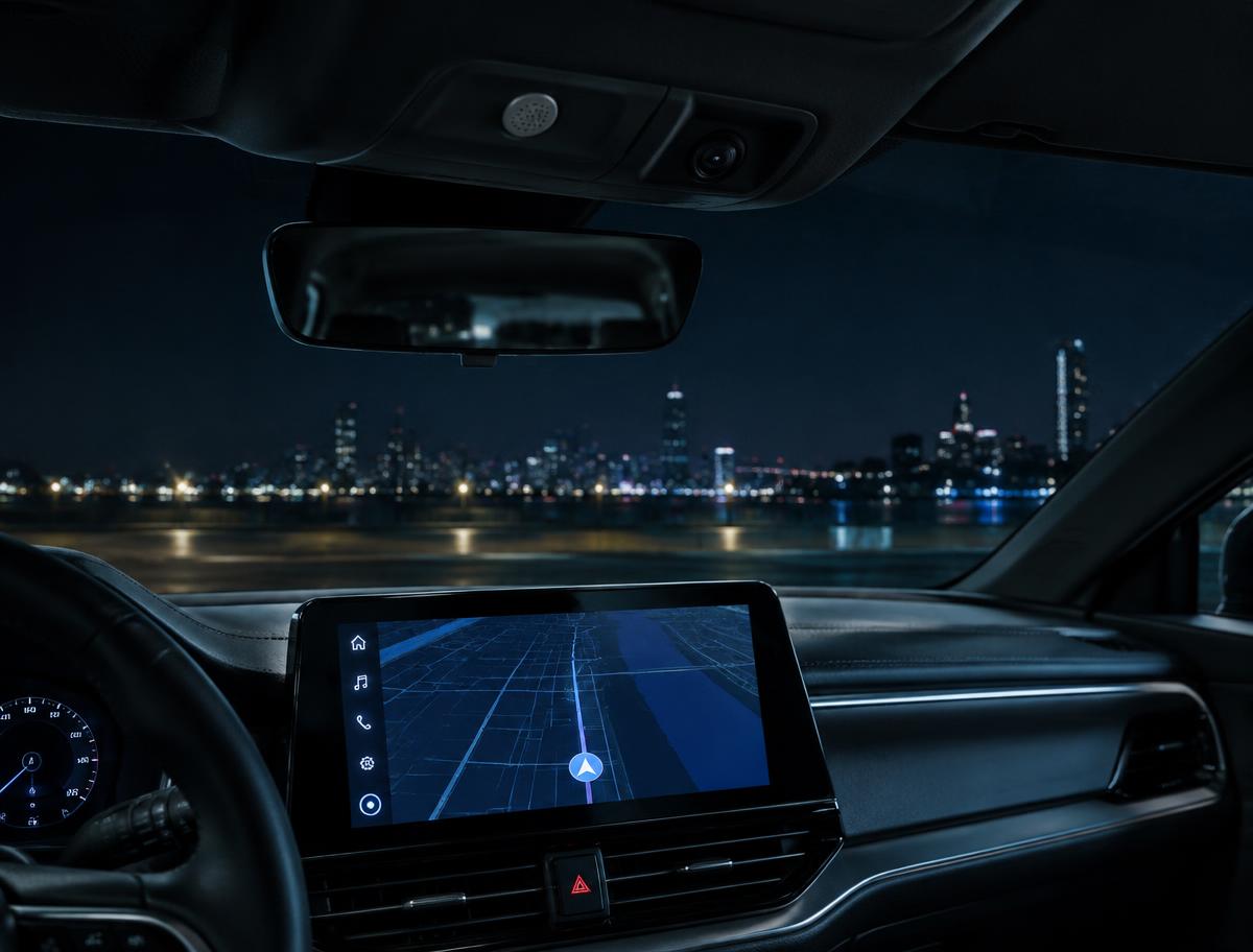Connected car interior at night with satnav screen, cabin microphone and camera