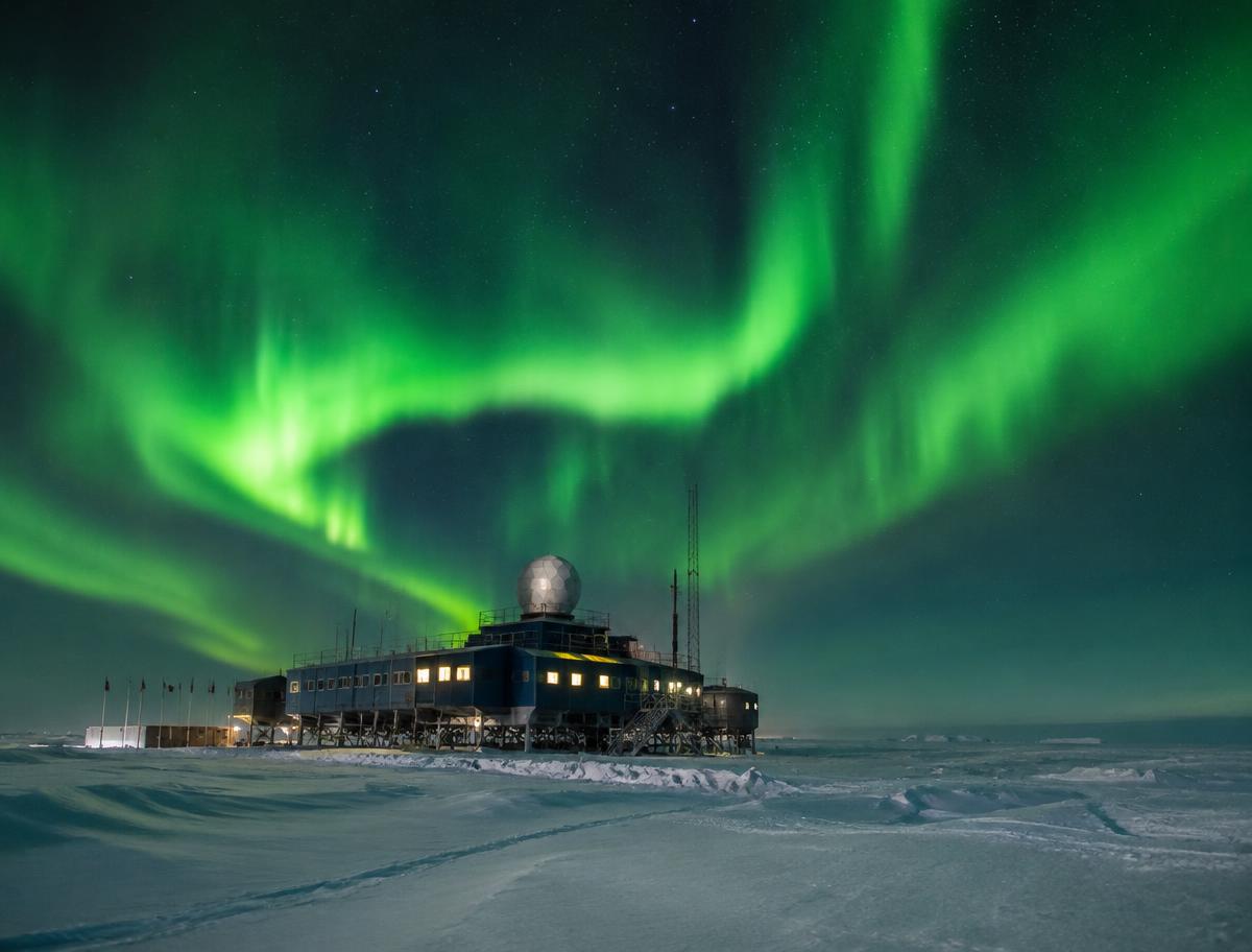 Illustrative polar research station under the aurora; not the IceCube laboratory